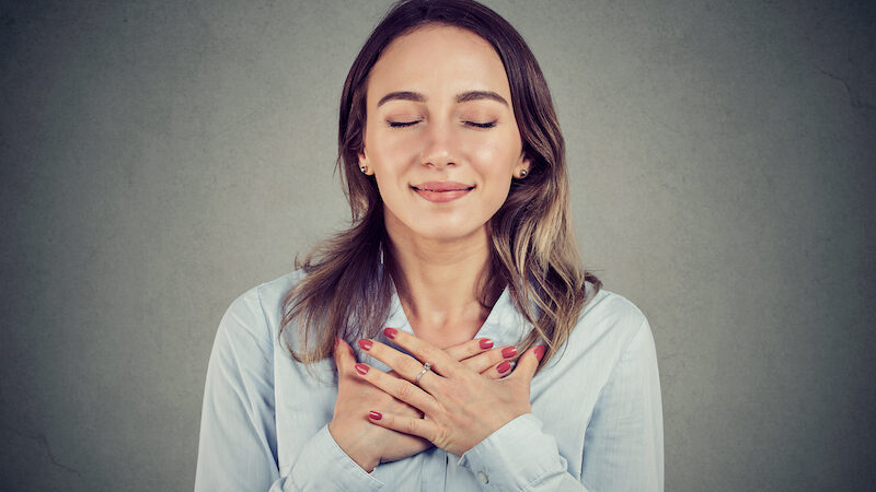 Bigstock Woman With Eyes Closed Keeps H 247507675