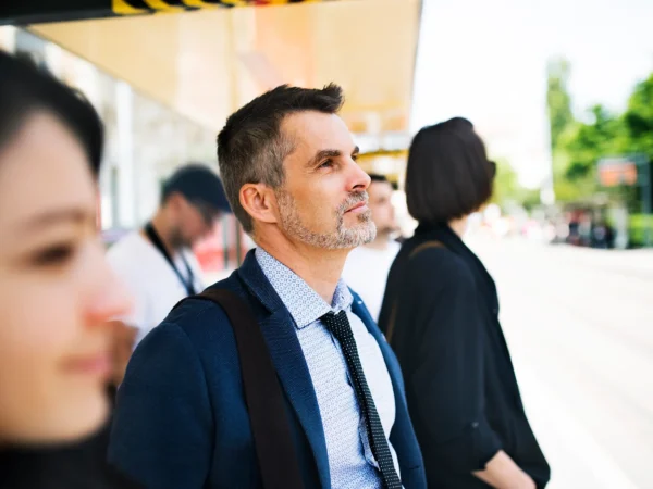 Man Standing At Bus Stop